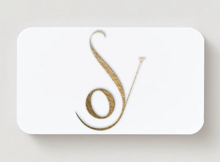 Front side of Orysia Vintoniak business card with a gold personal monogram.